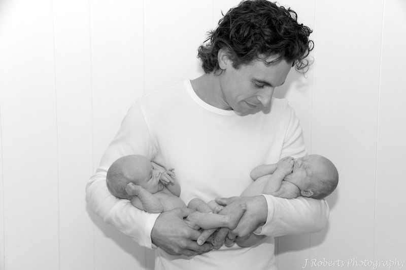 Father holding newborn twins in his arms - newborn baby portrait photography sydney